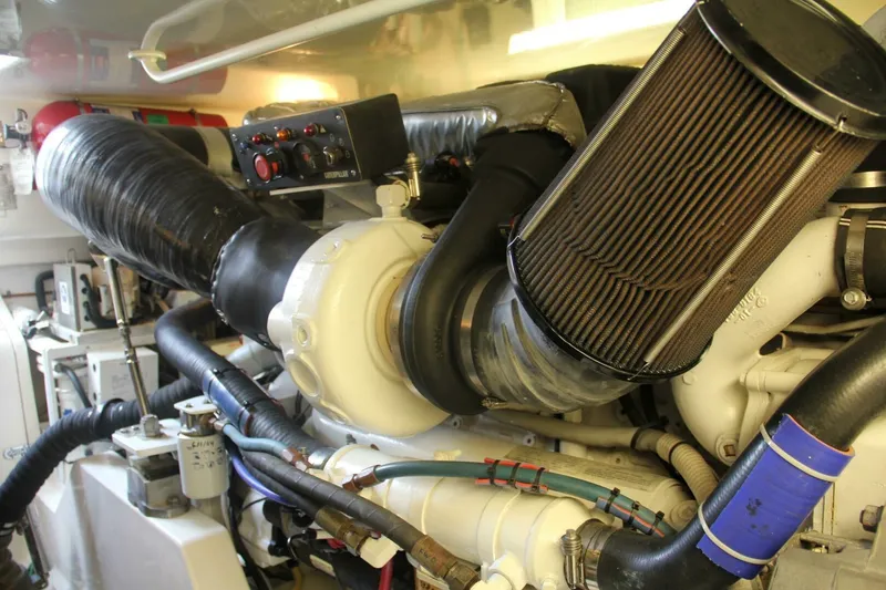 Slide: The Image of Engine room of 2004 Cabo 48 Flybridge yacht, showcasing detailed mechanical components. - 65