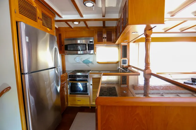 Slide: The Image of Luxurious 2008 Kadey-Krogen 48 North Sea yacht kitchen with modern appliances and wooden cabinetry. - 10