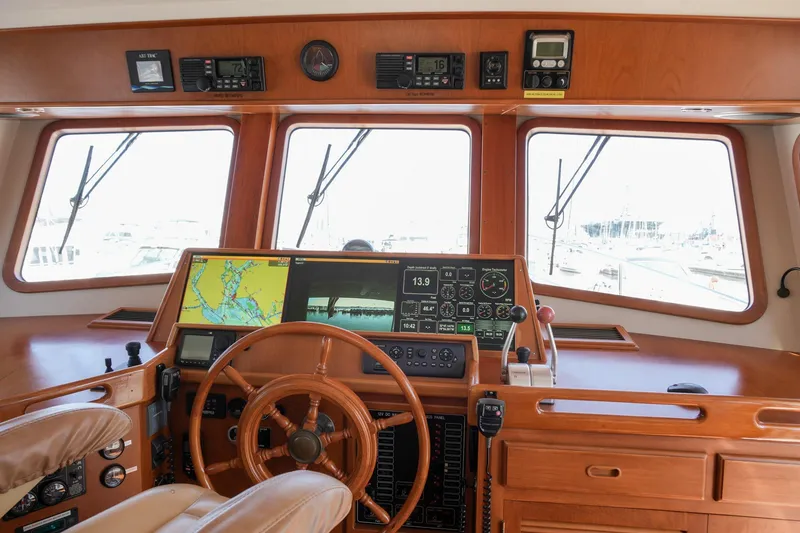 Slide: The Image of Pilothouse of 2008 Kadey-Krogen 48 North Sea yacht with navigation equipment and wooden steering wheel. - 27