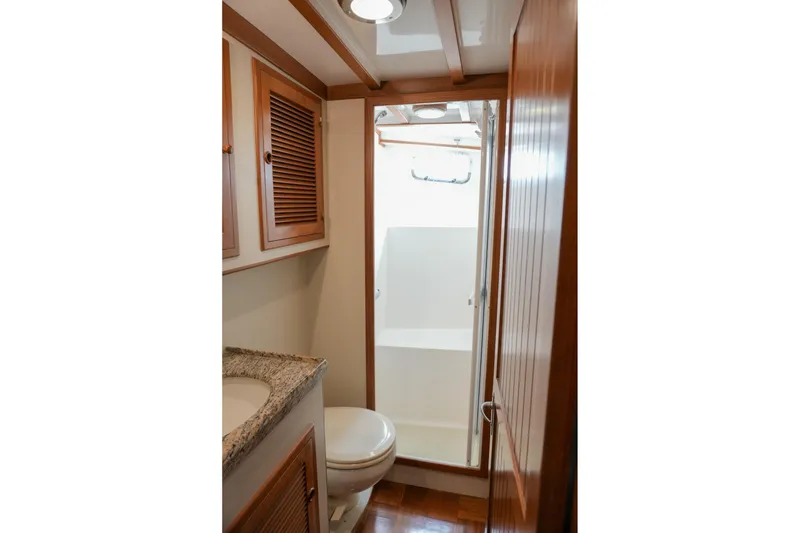 Slide: The Image of 2008 Kadey-Krogen 48 North Sea yacht bathroom with wooden cabinetry and granite countertop. - 39