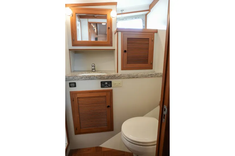 Slide: The Image of 2008 Kadey-Krogen 48 North Sea yacht bathroom with wooden cabinets and granite countertop. - 40
