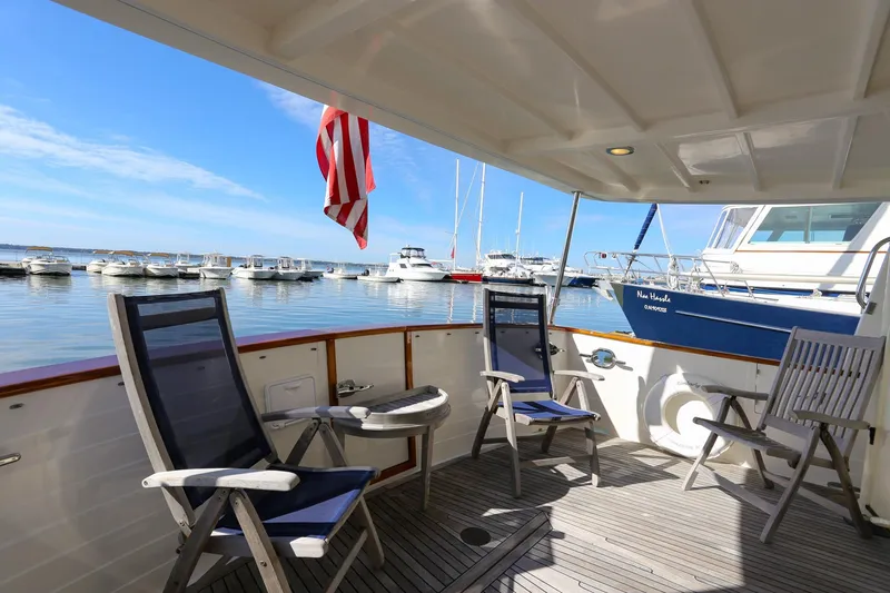 Slide: The Image of Outdoor seating on 2008 Kadey-Krogen 48 North Sea yacht, overlooking marina with boats. - 42