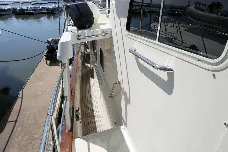 Slide: The Image of 2008 Kadey-Krogen 48 North Sea yacht docked, showcasing side deck and railing. - 51