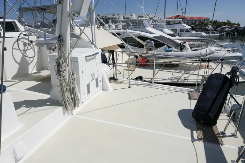 Slide: The Image of 2008 Kadey-Krogen 48 North Sea yacht deck with steering wheel and docked boats. - 56