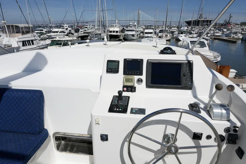 Slide: The Image of Helm of 2008 Kadey-Krogen 48 North Sea yacht in marina setting. - 58