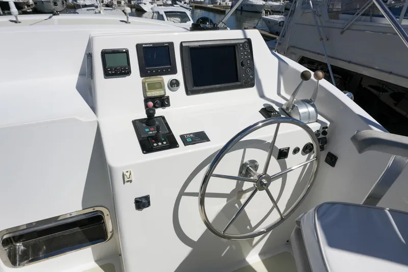Slide: The Image of Helm of 2008 Kadey-Krogen 48 North Sea yacht with navigation instruments and steering wheel. - 59