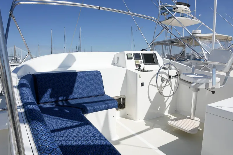 Slide: The Image of 2008 Kadey-Krogen 48 North Sea yacht cockpit with blue seating and navigation controls. - 60