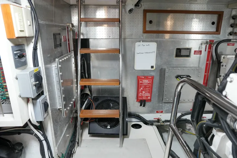 Slide: The Image of Engine room of 2008 Kadey-Krogen 48 North Sea yacht with metal walls and wooden steps. - 68
