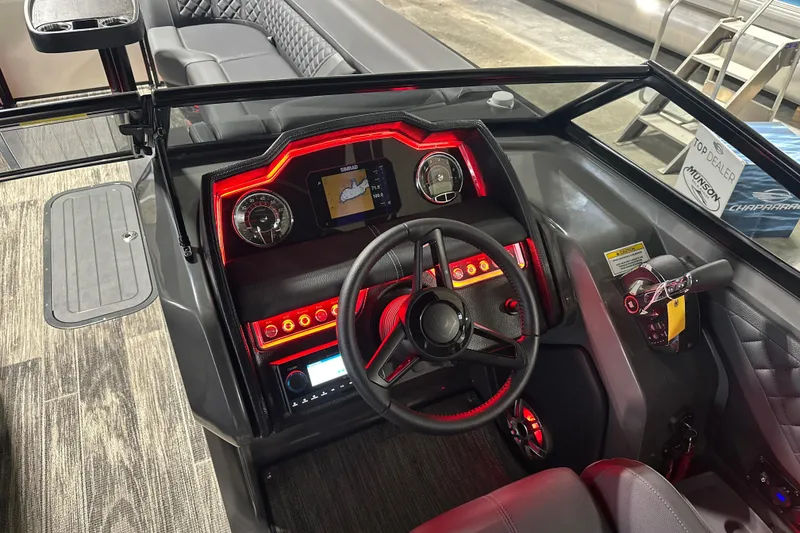 Slide: The Image of Interior of 2026 Godfrey AP 255 DFLW boat with illuminated dashboard and steering wheel. - 15