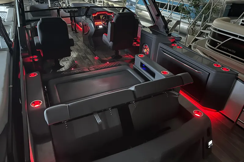 Slide: The Image of Interior of 2026 Godfrey AP 255 DFLW boat with red LED lighting and modern seating. - 17