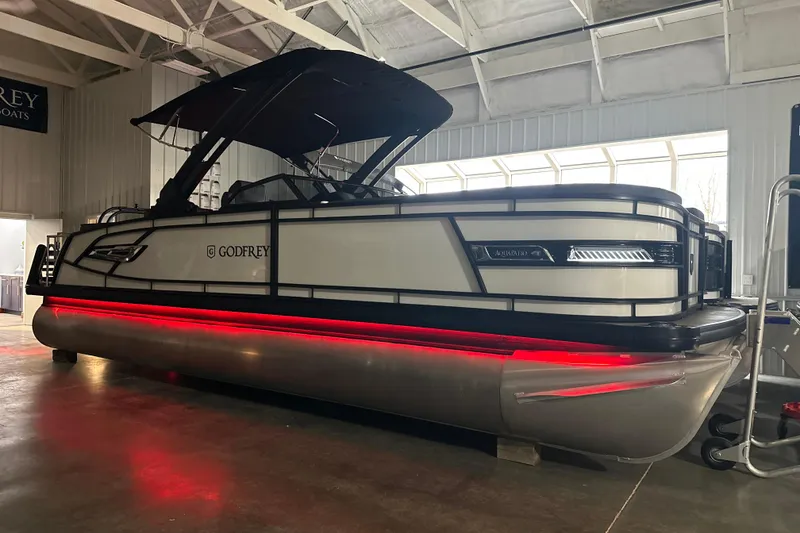Slide: The Image of 2026 Godfrey AP 255 DFLW pontoon boat with sleek design and red underglow lighting. - 20