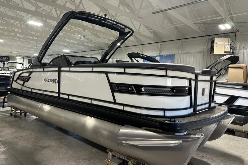 Slide: The Image of 2026 Godfrey AP 255 DFLW pontoon boat in showroom, sleek design, modern features. - 5