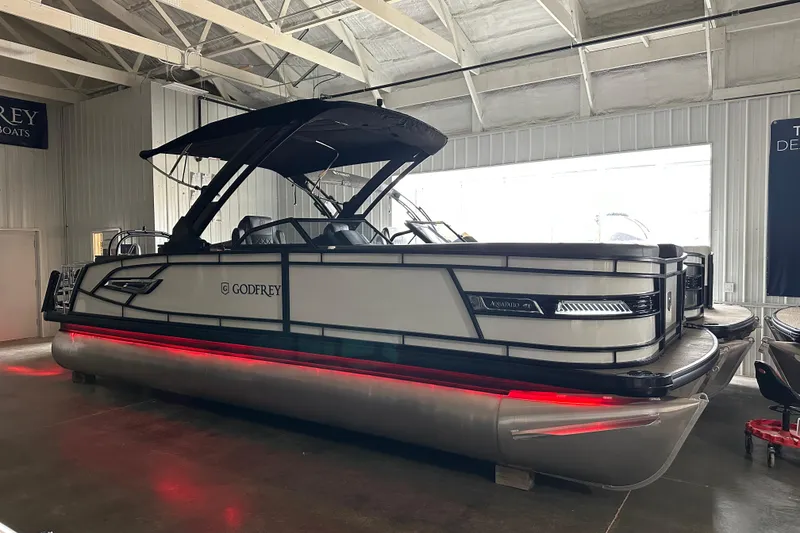 Slide: The Image of 2026 Godfrey AP 255 DFLW pontoon boat with sleek design and red underglow lighting. - 6