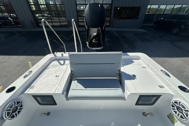 Slide: The Image of 2026 Sportsman Masters 247 Bay Boat with seating and storage compartments. - 11