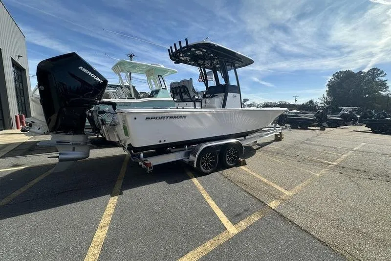 Slide: The Image of 2026 Sportsman Masters 247 Bay Boat on trailer, parked outdoors under clear sky. - 2