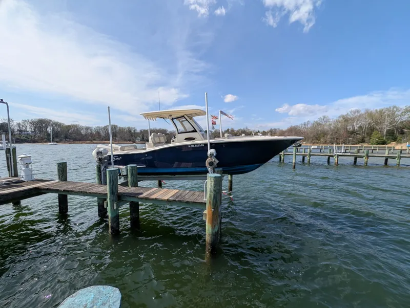 Slide: The Image of 2024 Scout 277 LXF boat on a dock in sunny weather. - 28