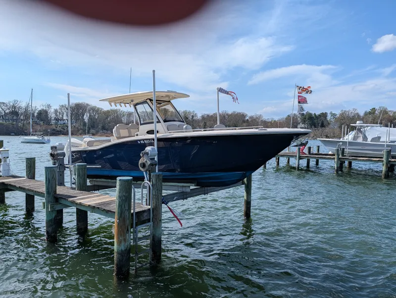 Slide: The Image of 2024 Scout 277 LXF boat docked on a sunny day. - 29
