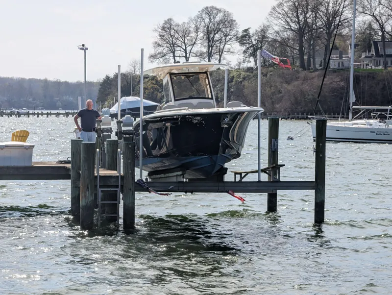 Slide: The Image of 2024 Scout 277 LXF boat on a dock by the water. - 33