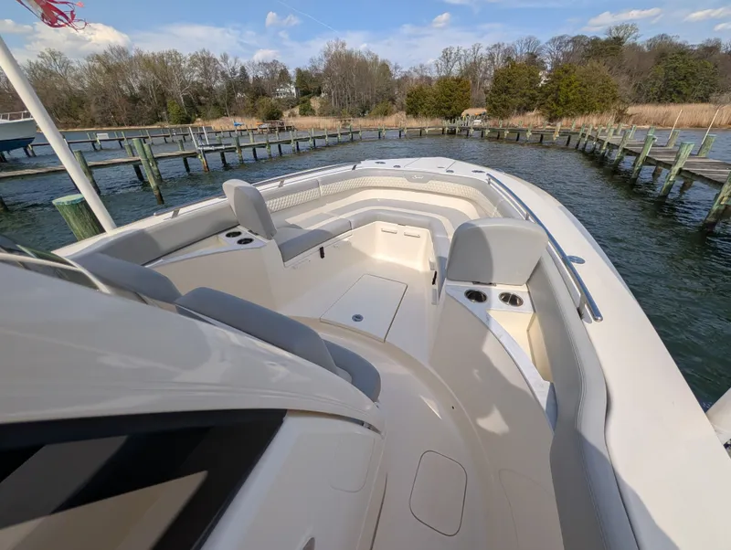 Slide: The Image of 2024 Scout 277 LXF boat at dock with seating area. - 34