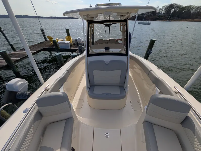 Slide: The Image of 2024 Scout 277 LXF boat at dock with seating area. - 36