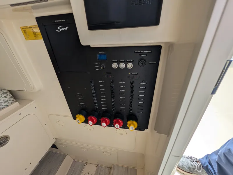 Slide: The Image of 2024 Scout 277 LXF boat control panel with switches and indicators. - 38