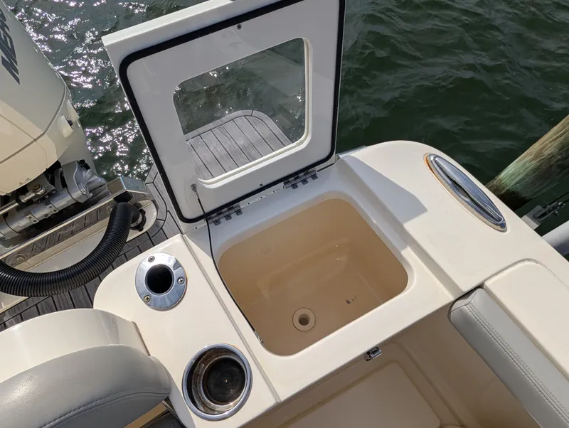 Slide: The Image of 2024 Scout 277 LXF boat with open storage compartment at the stern. - 40