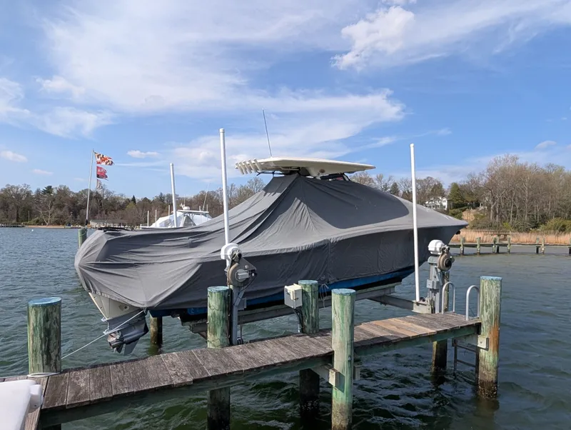 Slide: The Image of 2024 Scout 277 LXF boat covered at a dock. - 46
