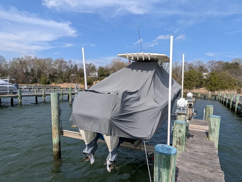 Slide: The Image of 2024 Scout 277 LXF boat covered at dock. - 47