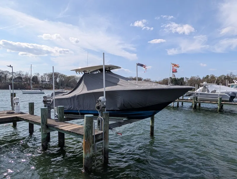 Slide: The Image of 2024 Scout 277 LXF boat docked and covered. - 48