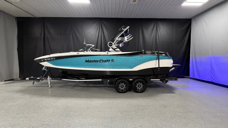 Slide: The Image of 2019 MasterCraft X24 boat on trailer in showroom. - 0