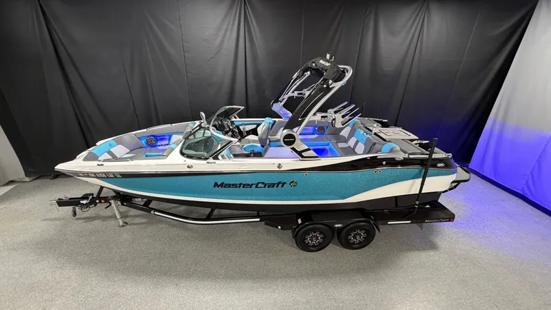Slide: The Image of 2019 MasterCraft X24 boat on trailer in showroom. - 1