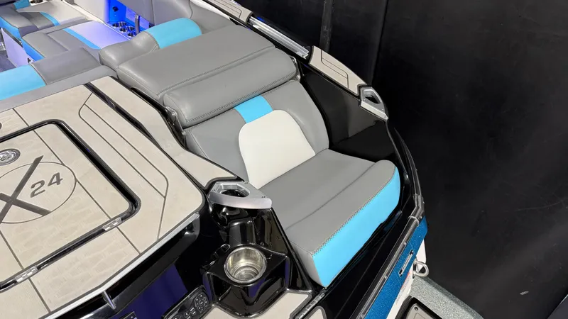 Slide: The Image of Interior of a 2019 MasterCraft X24 boat with gray and blue seating. - 21