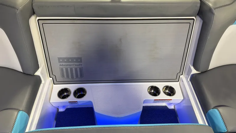Slide: The Image of MasterCraft X24 2019 boat interior with cup holders and blue lighting. - 34