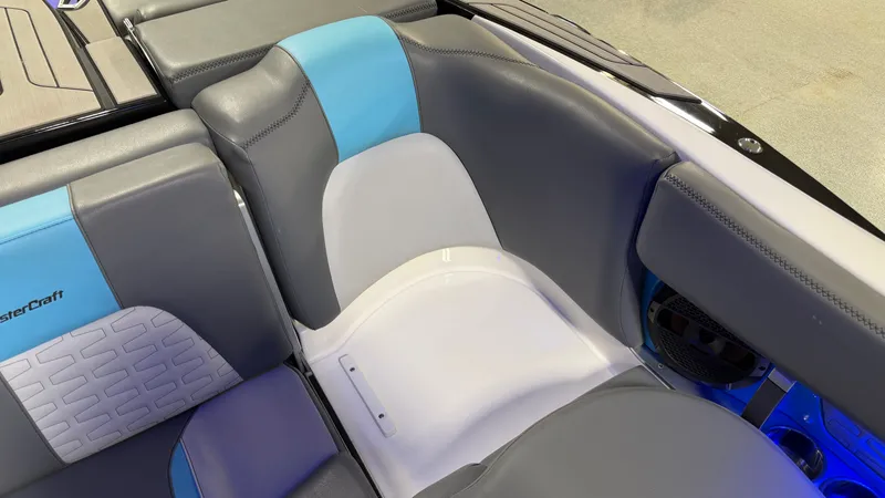 Slide: The Image of Interior of a 2019 MasterCraft X24 boat with gray and blue seating. - 49