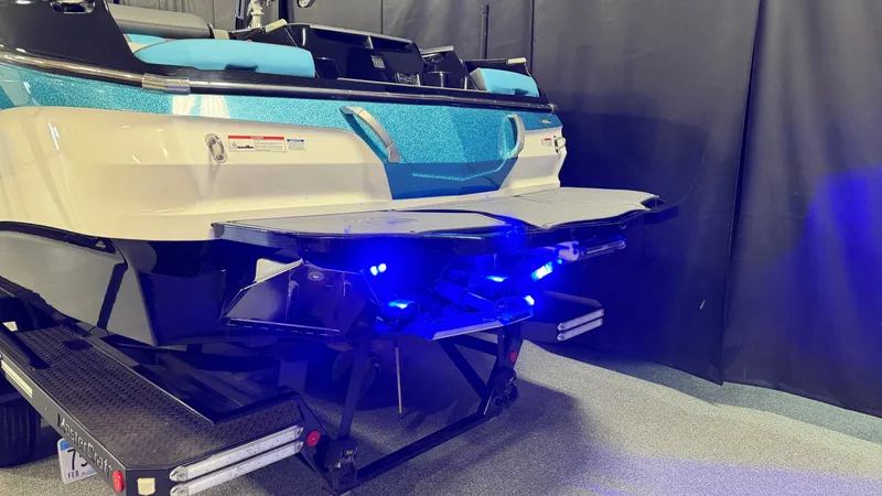 Slide: The Image of 2019 MasterCraft X24 boat with blue lighting at the rear. - 9