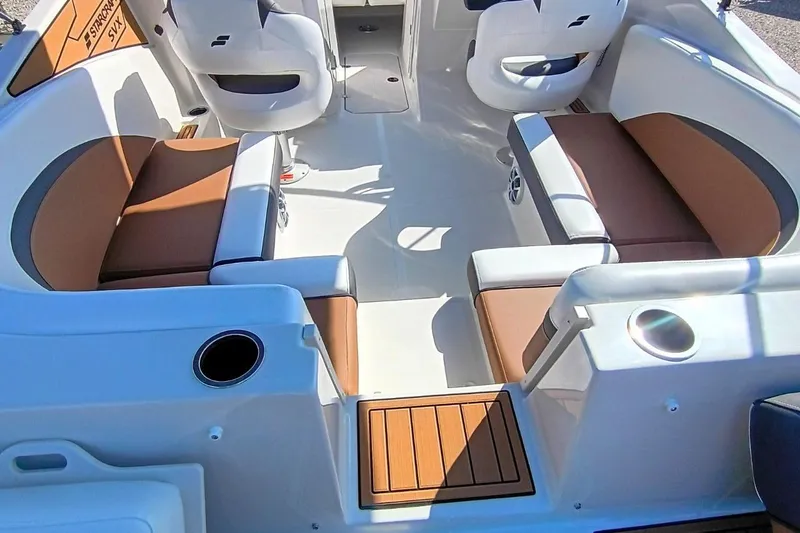 Slide: The Image of Interior of 2026 Starcraft SVX 230 DC OB boat with brown and white seating. - 11