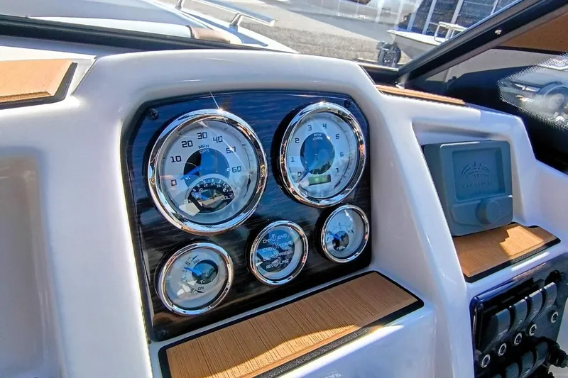 Slide: The Image of Dashboard of 2026 Starcraft SVX 230 DC OB boat with gauges and controls. - 14