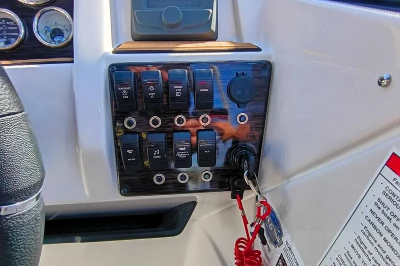Slide: The Image of Control panel of 2026 Starcraft SVX 230 DC OB boat with switches and ignition keys. - 17