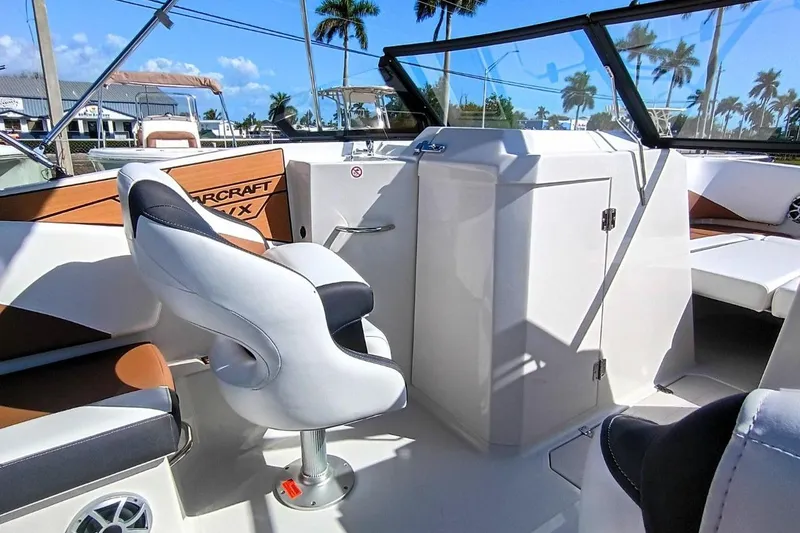 Slide: The Image of 2026 Starcraft SVX 230 DC OB boat interior with modern seating and dashboard. - 18