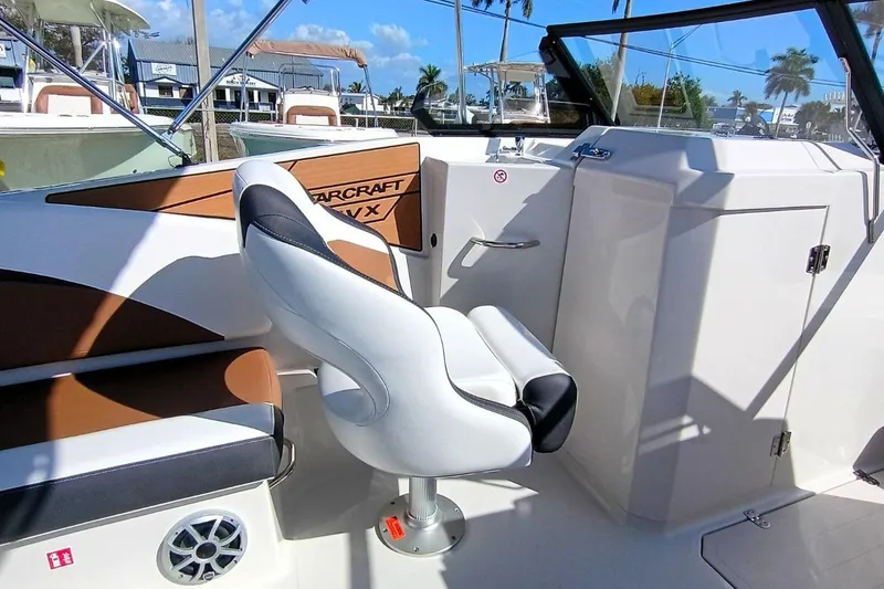 Slide: The Image of Interior of 2026 Starcraft SVX 230 DC OB boat with modern seating and dashboard. - 19