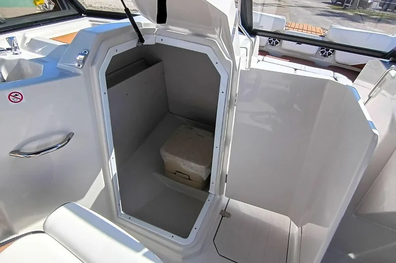 Slide: The Image of 2026 Starcraft SVX 230 DC OB boat interior with open storage compartment. - 20