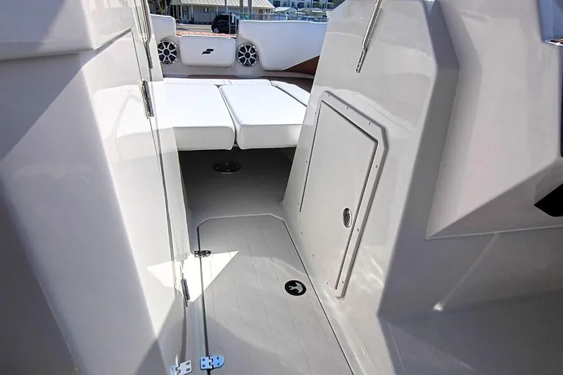Slide: The Image of Interior view of 2026 Starcraft SVX 230 DC OB boat, featuring seating and storage. - 25