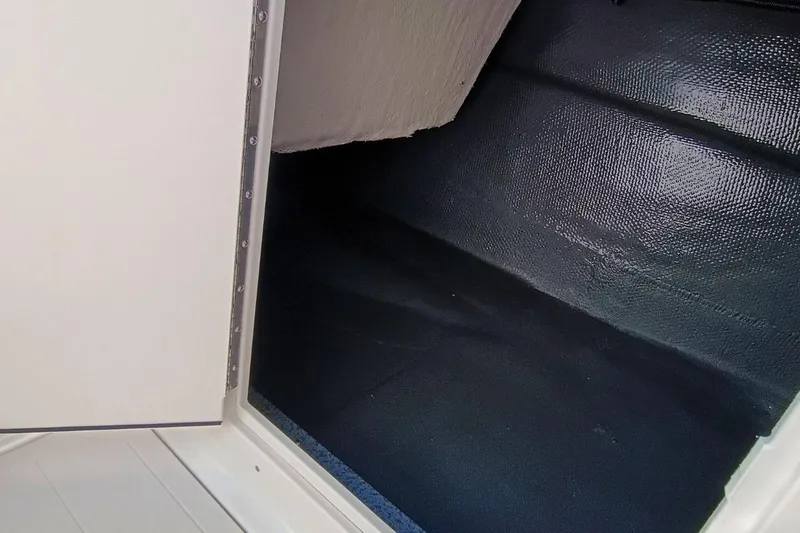 Slide: The Image of Storage compartment of 2026 Starcraft SVX 230 DC OB boat, featuring textured interior. - 26