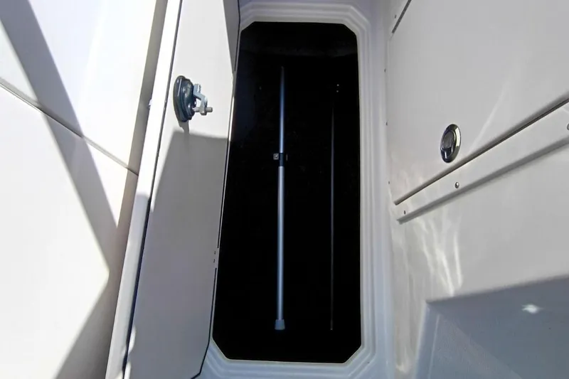 Slide: The Image of Storage compartment of 2026 Starcraft SVX 230 DC OB boat, open door view. - 27