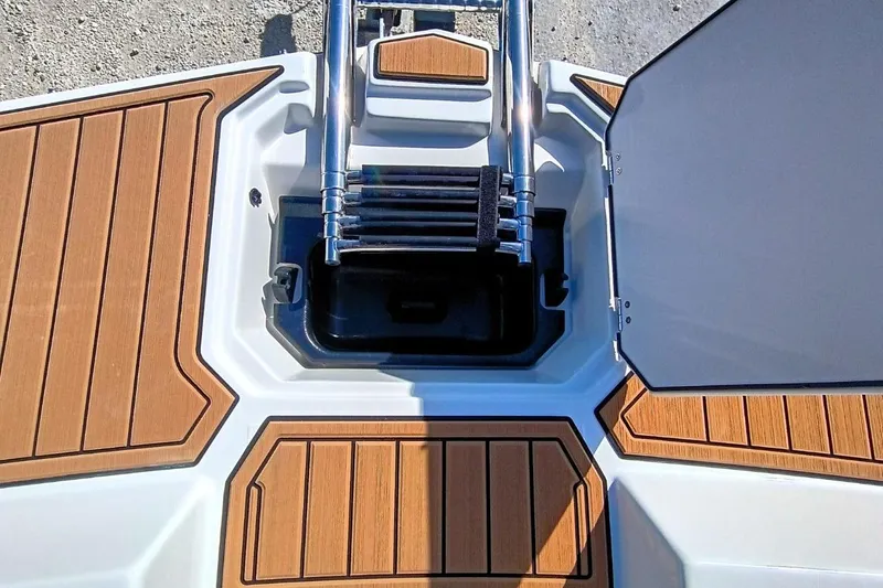 Slide: The Image of 2026 Starcraft SVX 230 DC OB boat ladder and deck with wood finish. - 29