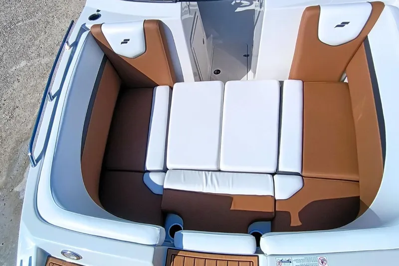 Slide: The Image of 2026 Starcraft SVX 230 DC OB boat interior with brown and white cushioned seating. - 30