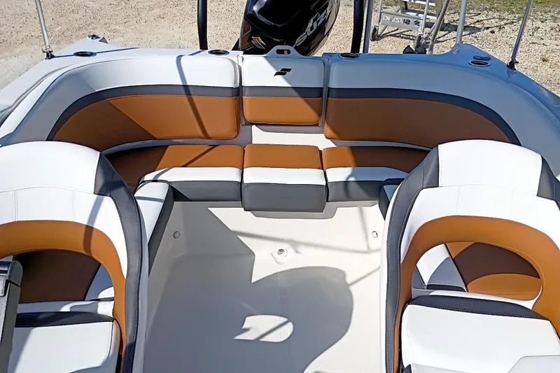 Slide: The Image of 2026 Starcraft SVX 230 DC OB boat interior with brown and white seating. - 33
