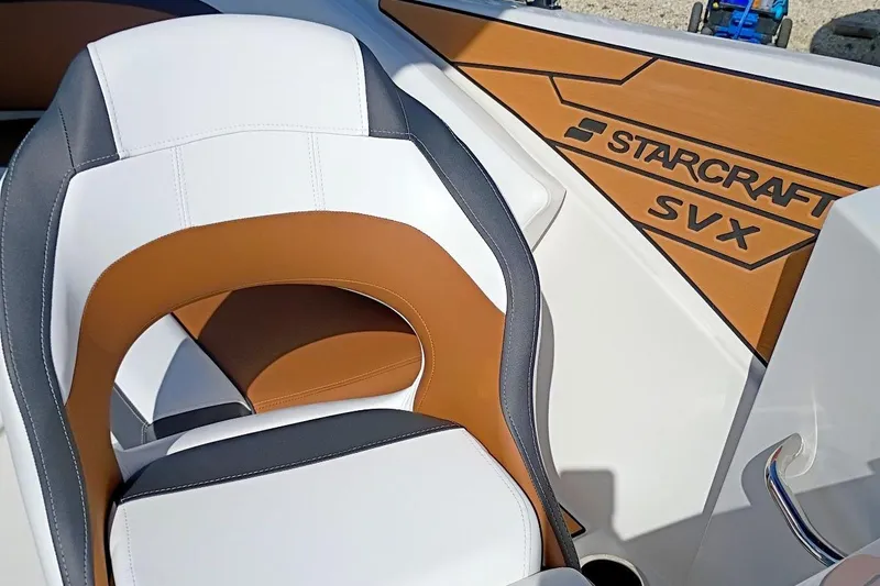 Slide: The Image of 2026 Starcraft SVX 230 DC OB boat interior with stylish seating and branding. - 34