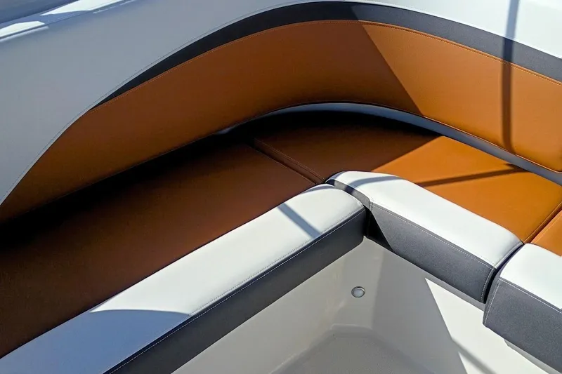 Slide: The Image of 2026 Starcraft SVX 230 DC OB boat interior with brown and white seating. - 35