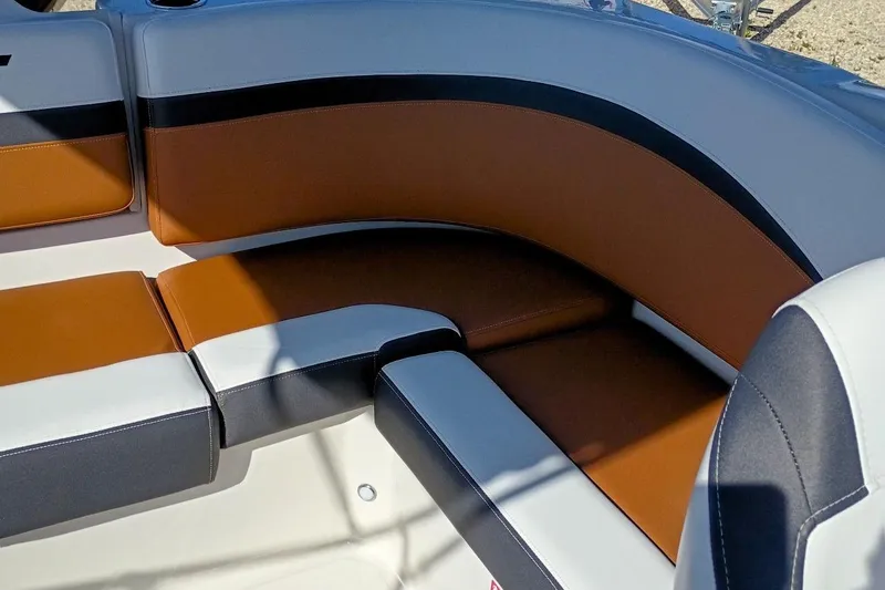 Slide: The Image of 2026 Starcraft SVX 230 DC OB boat interior with brown and white cushioned seating. - 38